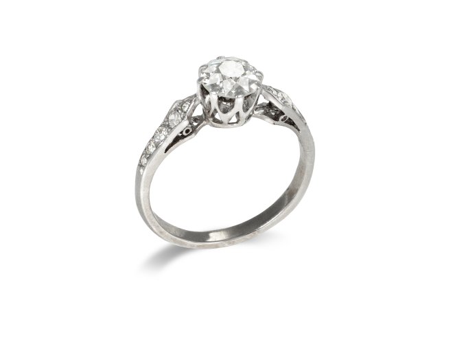 Diamond flanked solitaire ring, circa 1920. 