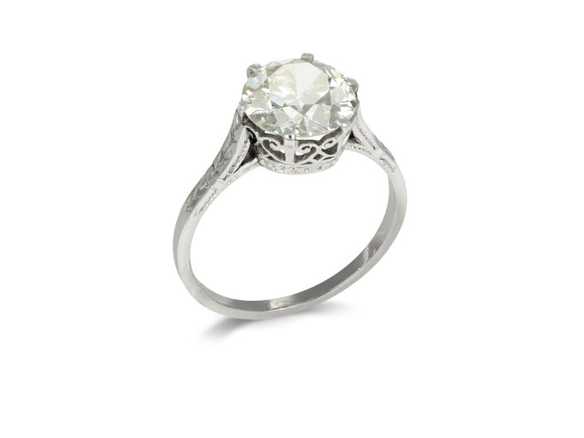 Old cut diamond flanked solitaire ring, circa 1920. 