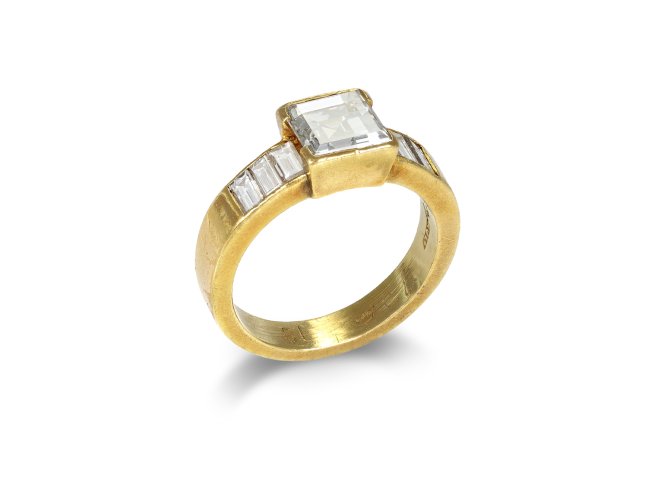 Square step cut flanked solitaire diamond ring, English, 1987.