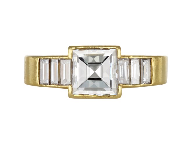 Square step cut flanked solitaire diamond ring, English, 1987.