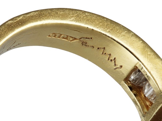 Square step cut flanked solitaire diamond ring, English, 1987.