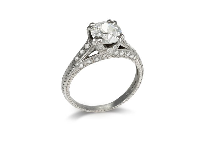 Diamond flanked solitaire ring, American circa 1940. 