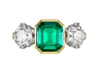 Colombian emerald and diamond flanked solitaire ring