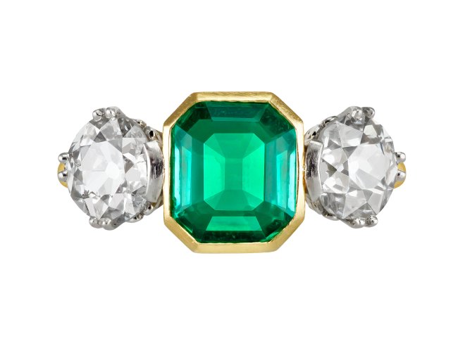 Colombian emerald and diamond flanked solitaire ring