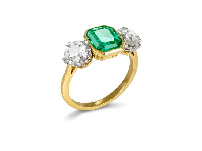 Colombian emerald and diamond flanked solitaire ring