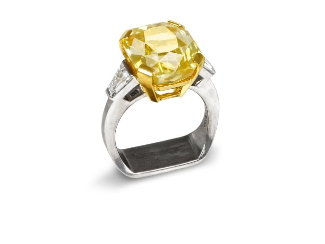 Yellow Ceylon sapphire and diamond flanked solitaire ring. 