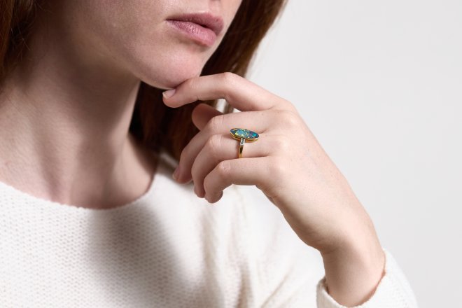 Black opal and diamond flanked solitaire ring, circa 1915.