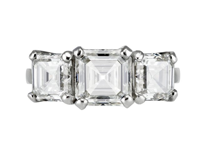 Step cut diamond three stone ring.