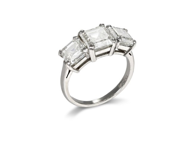 Step cut diamond three stone ring.