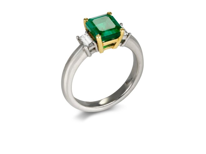 Colombian Emerald and diamond flanked solitaire ring. 