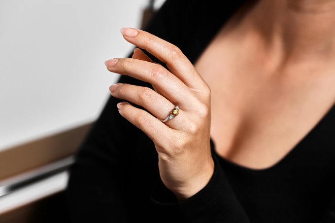 Tiffany & Co Fancy deep orange yellow diamond flanked solitaire, American.
