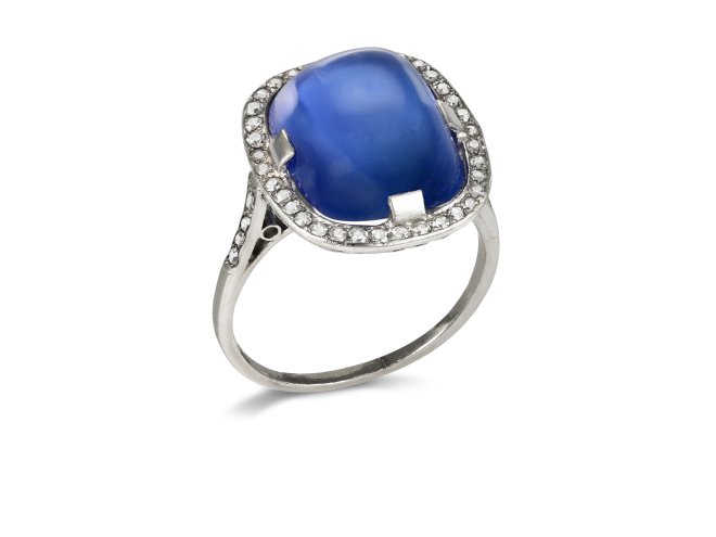 Ceylon cabochon sapphire and diamond cluster ring, early 20th Century. 