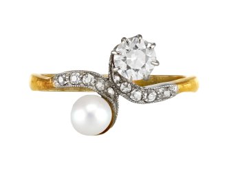 Natural pearl and diamond crossover ring, circa 1910. 