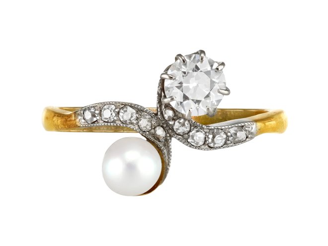 Natural pearl and diamond crossover ring, circa 1910. 