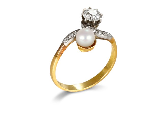 Natural pearl and diamond crossover ring, circa 1910. 
