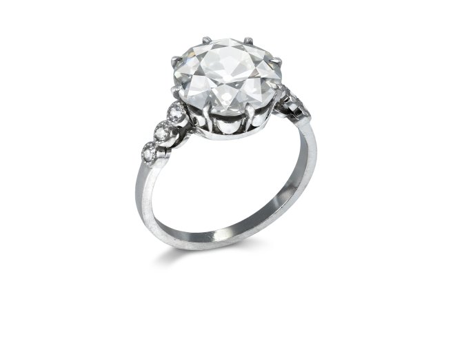 4.27 carat old cut diamond flanked solitaire ring, circa 1920. 