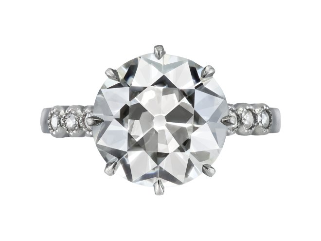 4.27 carat old cut diamond flanked solitaire ring, circa 1920. 