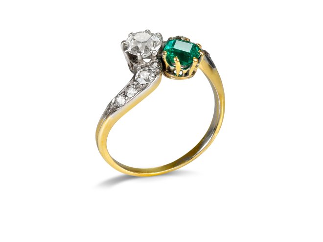Emerald and diamond crossover ring, circa 1910. 