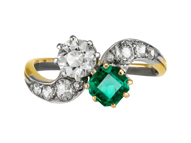 Emerald and diamond crossover ring, circa 1910. 