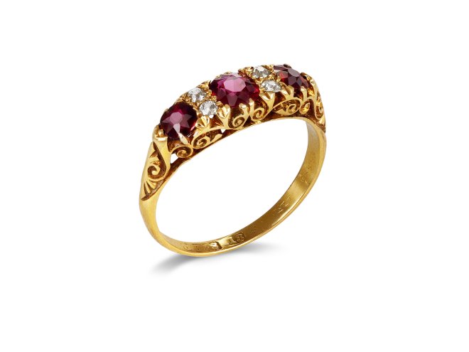 Ruby and diamond carved seven stone ring, late 19th century. 