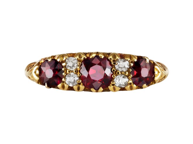 Ruby and diamond carved seven stone ring, late 19th century. 