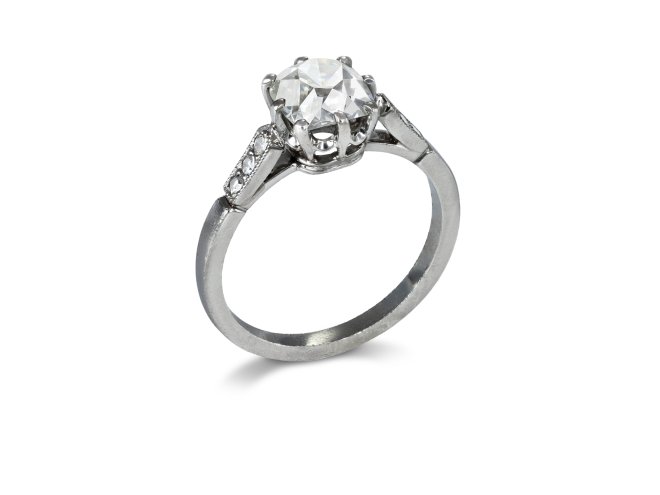 Peruzzi cut diamond flanked solitaire, early 20th Century.