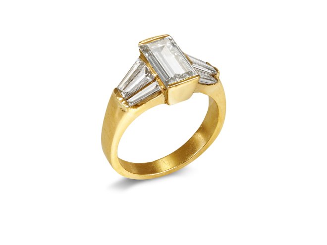 Rectangular step cut diamond flanked solitaire ring, late 20th Century. 