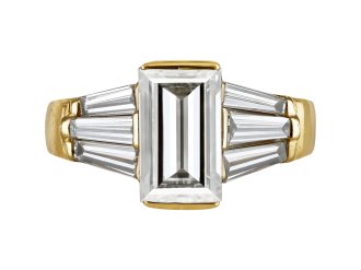 Rectangular step cut diamond flanked solitaire ring, late 20th Century. 