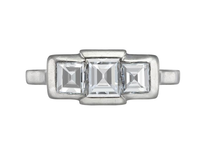 Step cut diamond three stone ring, French, early 20th Century. 
