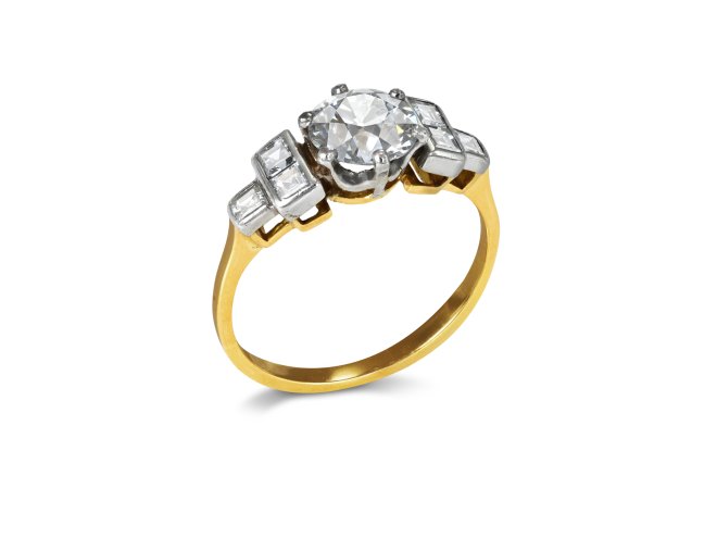 Diamond flanked solitaire ring, circa 1940.