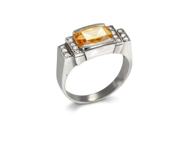 Orange Ceylon sapphire and diamond flanked solitaire ring, mid 20th century.
