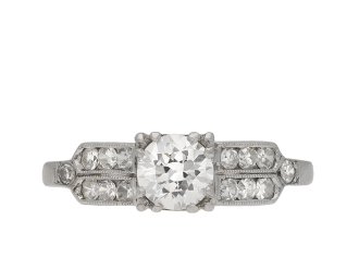 Diamond flanked solitaire ring, American, circa 1940.  Hatton Garden