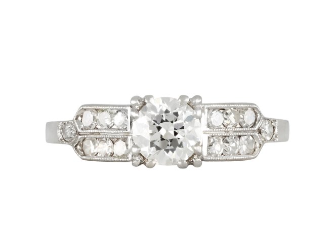 Diamond flanked solitaire ring, American, circa 1940.