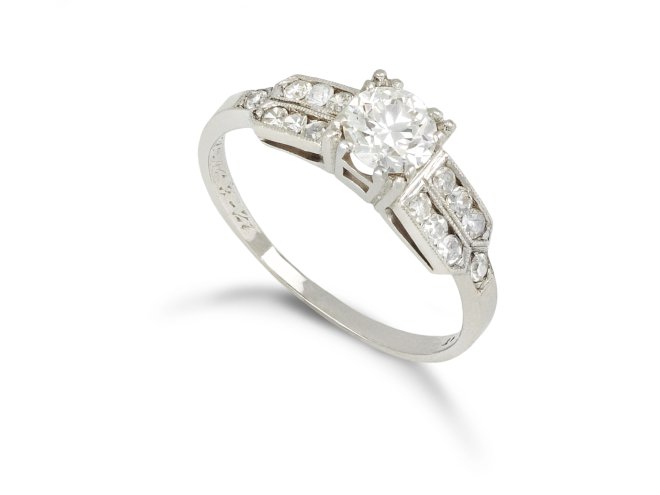 Diamond flanked solitaire ring, American, circa 1940.