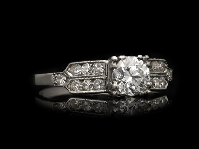 Diamond flanked solitaire ring, American, circa 1940.