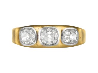 Three stone diamond gypsy ring, circa 1900.