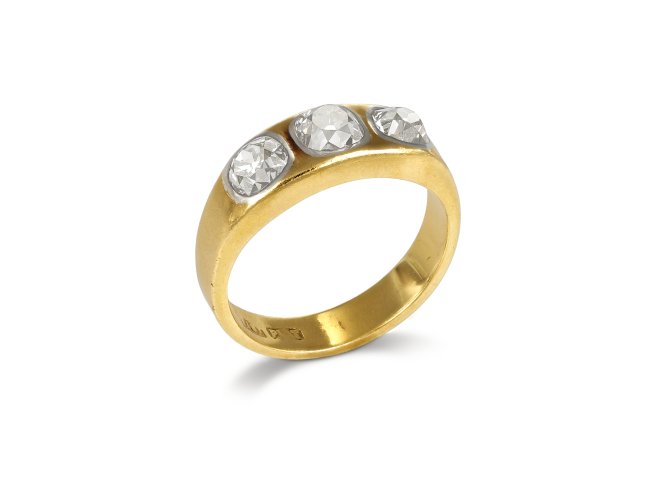Three stone diamond gypsy ring, circa 1900.