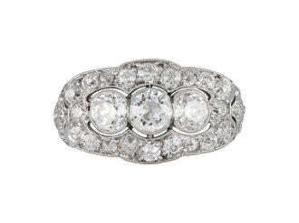 Three stone diamond cluster ring, circa 1920. 