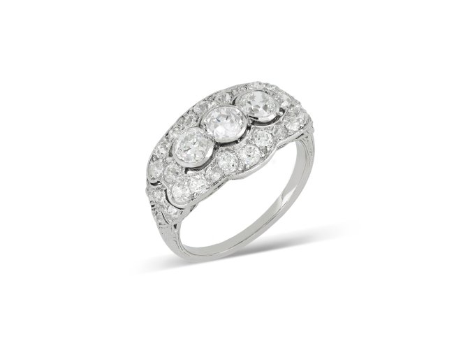 Three stone diamond cluster ring, circa 1920. 