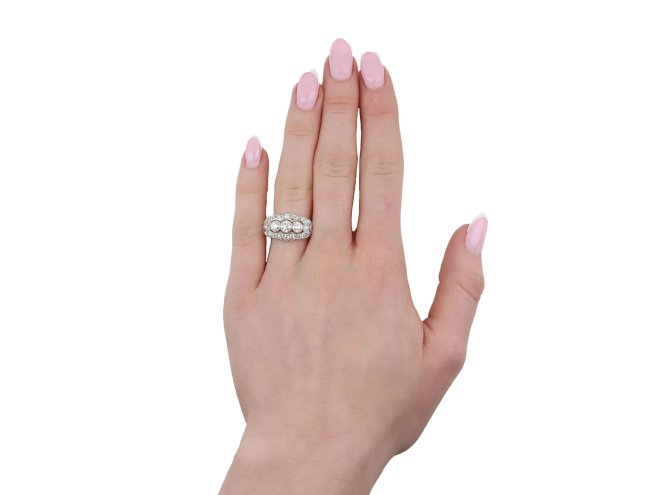 Three stone diamond cluster ring, circa 1920. 